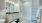 restroom with bright vanity and glass enclosed shower
