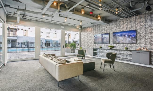 a room with tv couch and chairs