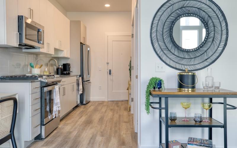 a kitchen with a mirror and bar cart